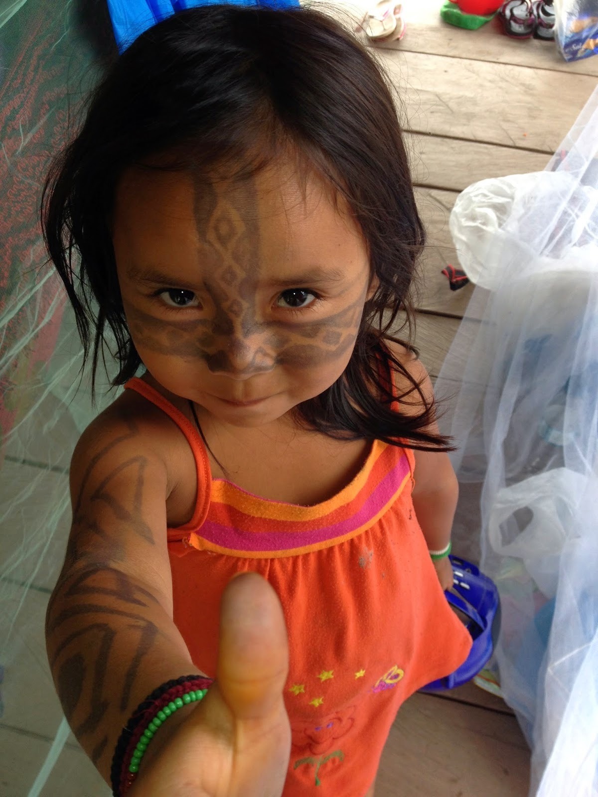 Huni Kuin child with traditional kene face painting